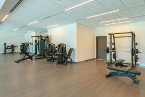 a gym with several treadmills and machines in a room at Luxury I Free Weekly Housekeeping I 5 Mins to Dubai Mall in Dubai