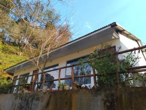 a house with a fence in front of it at Tay Bac Sky Homestay in Sa Pa
