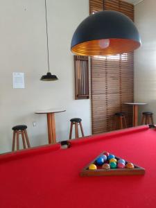 a red pool table with balls in a room at Harry World Parque Hotel in Curitibanos