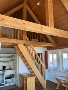 a wooden staircase in a room with a kitchen at Hotel & Landgasthof Zur Sonne 