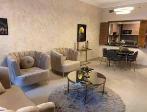a living room with couches and a table at Luxurious 1 bed Apt with Outdoor Patio - Madinat Badr in Dubai