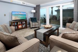 a living room with two couches and a tv at SO 101 - Large 3 BR Beachfront Ground Floor Condo in Fort Walton Beach