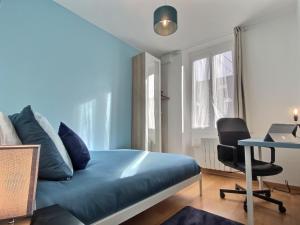 una camera blu con letto e scrivania di Charmant T3 Centre ville - Cozy Houses a Reims