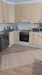 a kitchen with white cabinets and a stove top oven at Apartment Lapväärtti, kaksio in Lapväärtti