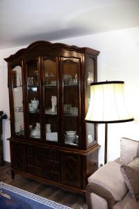 a china cabinet with a lamp in a living room at Apartment Blaoss in Karlovac