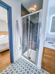 a shower with a glass door in a bathroom at The Kinsale 4 Center in Kinsale
