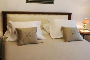 a bed with a bunch of pillows on it at Apartment Blaoss in Karlovac