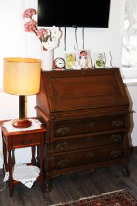 a wooden dresser with a lamp on a side table at Apartment Blaoss in Karlovac