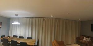a room with a curtain and a table and chairs at Reykjavík City Town Apartments in Reykjavík