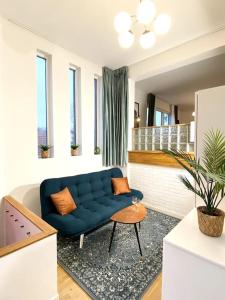 a living room with a blue couch and a table at Apartment Aekta Studio 3 Gothenburg in Gothenburg