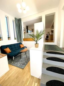 a living room with a blue couch and a chair at Apartment Aekta Studio 3 Gothenburg in Gothenburg