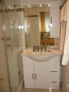 a bathroom with a sink and a shower at Central City Apartment Vienna in Vienna