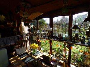 a room with a window filled with lots of vases at NELSONS CABIN in North Creake