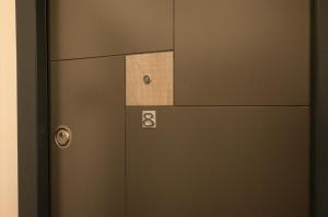 a door with a piece of wood on it at Luana Airport Apartments #8 in Otopeni +2 photos