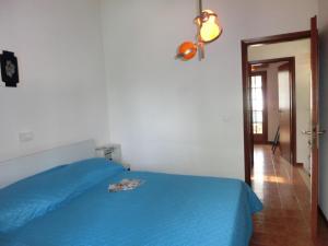 比比翁的住宿－Welcoming accommodation in Bibione - Beahost，一间卧室配有蓝色的床和蓝色的毯子
