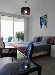 a living room with a bed and a glass table at Costa Adeje Ocean View Apartment in Adeje