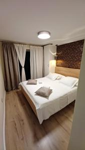 a bedroom with a large bed with white sheets at Holiday House Terezija in Baška Voda