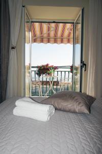 a bedroom with a bed with a view of a balcony at Holiday House Terezija in Baška Voda