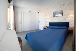 a bedroom with a blue bed in a room at L´Hostalet in Tossa de Mar
