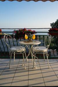 a table and chairs on a balcony with oranges on it at Holiday House Terezija in Baška Voda