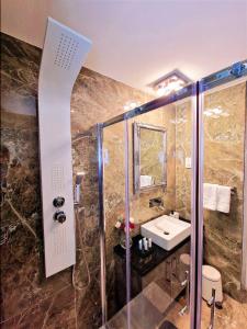 a bathroom with a shower and a sink and a shower at Sveltos Residence Suites in Larnaka