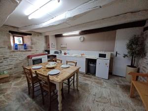 a kitchen with a table and chairs in a room at Wisteria Cottage at Gites de la Vienne in Chaunay