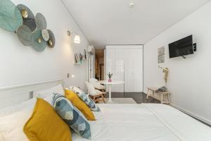 1 dormitorio con 1 cama con almohadas amarillas y azules en Taylors apartment by Innkeeper en Vila Nova de Gaia