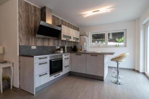 a kitchen with white cabinets and a counter top at Ferienwohnung Landurlaub in Irsch