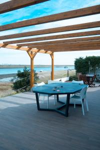 a blue ping pong table on a patio with the beach at Wax Hostel in Faro