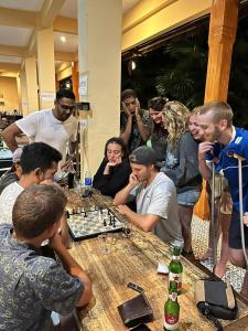 Eine Gruppe von Menschen, die Schach spielen in der Unterkunft Botchan Hostel in Kuta Lombok