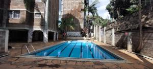 a swimming pool in the middle of a building at Homes By Lavender , Westlands in Nairobi