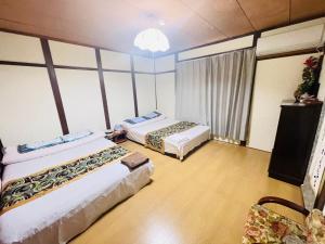 Postel nebo postele na pokoji v ubytování Shiga Biwa Lake Shanshui House