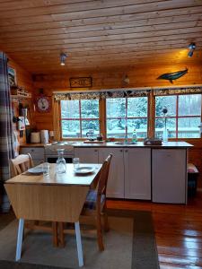a kitchen with a table and a table and chairs at Bakkakot 1 - Cozy Cabins in the Woods in Akureyri
