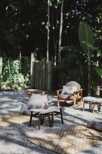 a group of chairs and tables in a yard at CASA SUKHA Hotel in Trancoso
