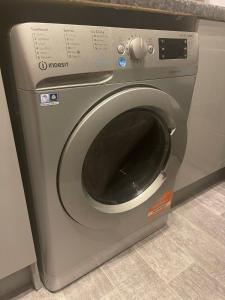 a washing machine in a kitchen with its door open at A lovely 3 bedroom family house! in Seaham