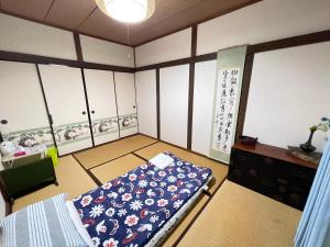 Postel nebo postele na pokoji v ubytování Shiga Biwa Lake Shanshui House