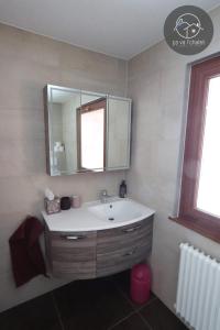a bathroom with a sink and a mirror at Chalet LES MARMOTTES, Ovronnaz in Ovronnaz