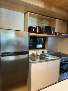 a kitchen with a stainless steel refrigerator and a sink at VIVERO 5 UF15 in San Martín de los Andes