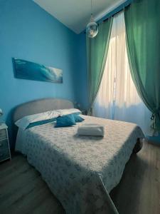 a blue bedroom with a bed with a pillow on it at Cicerone Guest House in Florence
