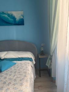 a bedroom with blue walls and a bed with a table at Cicerone Guest House in Florence
