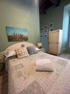 a bedroom with a large bed with two pillows on it at Cicerone Guest House in Florence