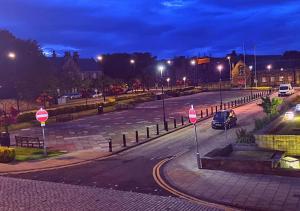 Una calle por la noche con coches conduciendo por la carretera en Double Ensuite Bedroom near Edinburgh en Kirkcaldy