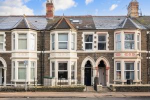 a large brick building with a door on a street at Apartment Nr City Centre & Park For up to 6 in Cardiff