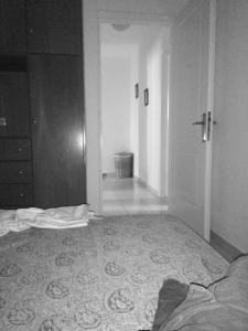 an empty room with a bed and a hallway at HOUSE 3Bedroom Maisonette ΕΞΟΧΙΚΟ Alyki PAROS 50m from BEACH ideal for families in Aliki
