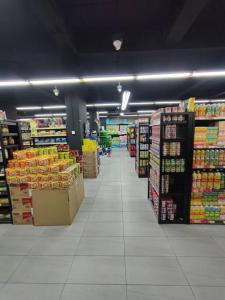 a store aisle of a grocery store with products at Kuching Luxurious Town Area Apartment in Kuching