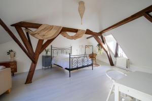a bedroom with a bed in a room with wooden beams at De Hilde in Zutphen