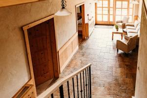 a staircase with a wooden door in a living room at Kakukk Vendéglő Panzió in Bánd