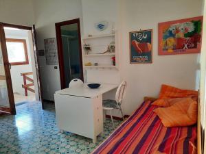 a small room with a desk and a bed at Attico cavo a pochi passi dal mare in Cavo