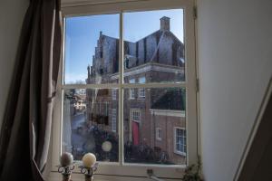 a window with a view of a city at De Hilde in Zutphen