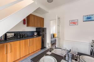 a kitchen with a table with plates on it at Charming Terraced House in Central Hoylake in Hoylake